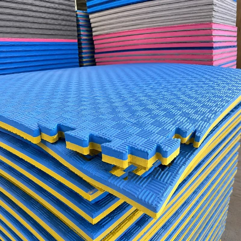 Wholesale EVA tatami mats stacked in a manufacturing workspace